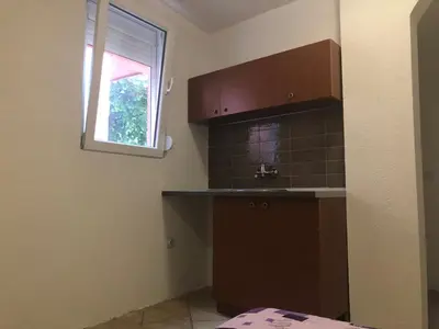 a kitchen with a sink and a window at Apartmani Pavicevic in Podgorica