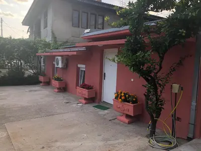 a red house with a bunch of oranges on the door at Apartmani Pavicevic in Podgorica