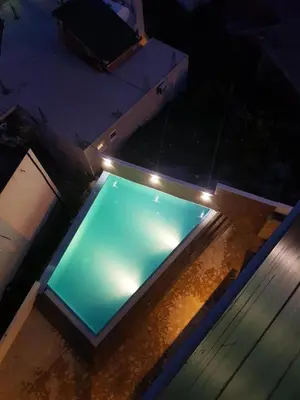 an overhead view of a swimming pool with lights at Apartment L'ideal in Ulcinj