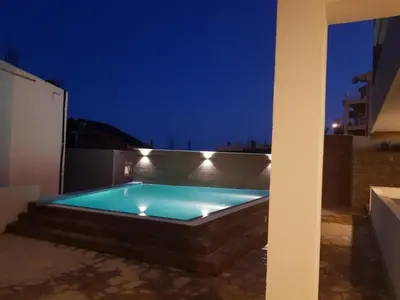 a swimming pool at night on a rooftop at Apartment L'ideal in Ulcinj