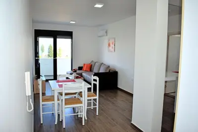 a living room with a table and a couch at Apartment L'ideal in Ulcinj