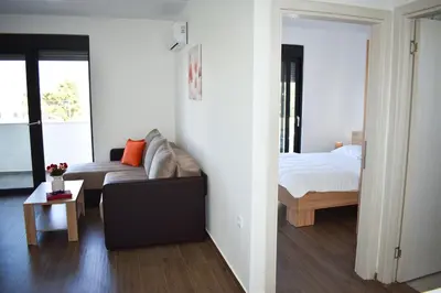 a living room with a couch and a bed at Apartment L'ideal in Ulcinj