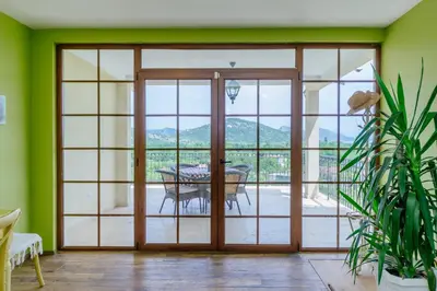 a room with a sliding glass door with a table at RUSTIC HOUSE LEKOVIĆ in Virpazar