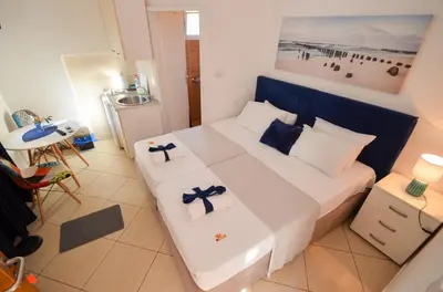 a small room with a bed with two crosses on it at Tea apartments in Kotor