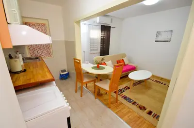 a small kitchen and dining room with a table and chairs at Tea apartments in Kotor