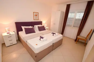 a bedroom with a bed with two towels on it at Tea apartments in Kotor