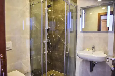 a bathroom with a glass shower and a sink at Hotel Prova in Ulcinj