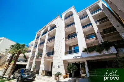 a building with a car parked in front of it at Hotel Prova in Ulcinj