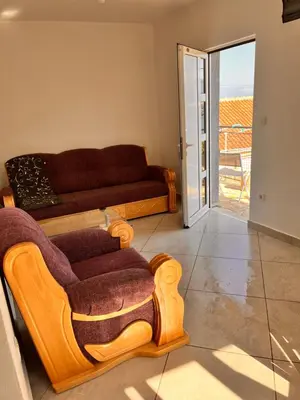 a living room with a couch and a chair at Apartments Apartmani Bojana in Utjeha