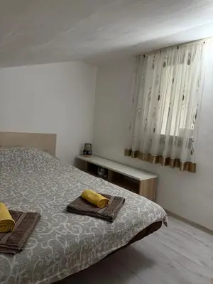a bedroom with a bed with two towels on it at Apartment viva Jelena in Budva