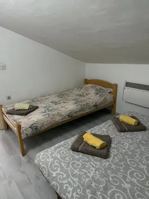 two twin beds in a room with at Apartment viva Jelena in Budva