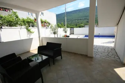 a living room with a view of a pool at Apartmani Srdanovic in Tivat