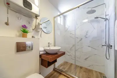 a bathroom with a shower and a sink at Mika's Seaview Apartments in Bar