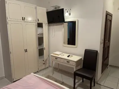 a small bedroom with a desk and a chair at Apartments Kalaja in Ulcinj