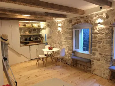 a kitchen and dining room with a table and chairs at Chic & Stylish with Seaview-Terrace - Kotor Indah in Kotor