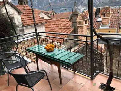 a table with fruit on it on a balcony at Chic & Stylish with Seaview-Terrace - Kotor Indah in Kotor
