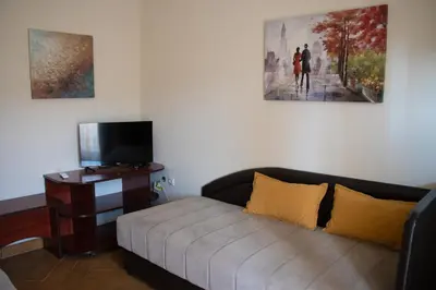 a living room with a couch and a tv at Apartmani Nilaj in Ulcinj