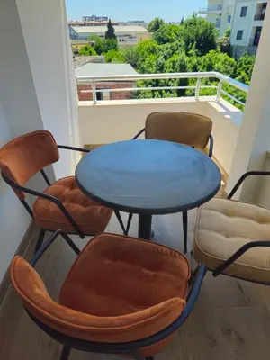 a table and four chairs sitting on a balcony at Apartmani Nilaj in Ulcinj