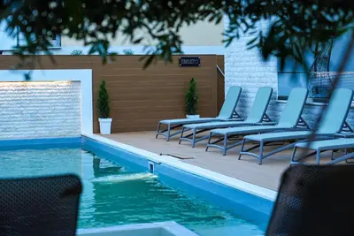 a row of chairs sitting next to a swimming pool at Apartmani Nilaj in Ulcinj