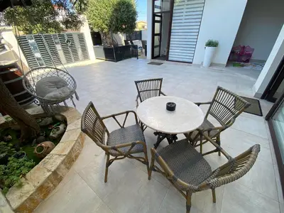 a patio with a table and chairs on a patio at Apartmani Nilaj in Ulcinj