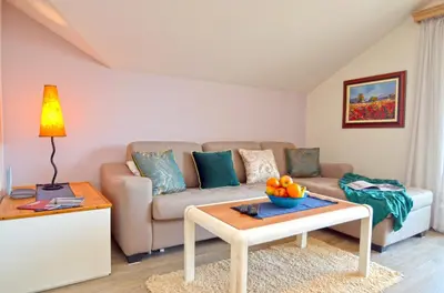 a living room with a couch and a table at Apartments Olive in Kotor