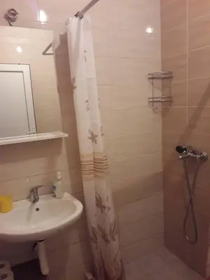 a bathroom with a shower curtain and a sink at Apartmani Andrea-jaz in Budva