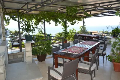 a table and chairs on a patio with a view at Apartments Amina in Ulcinj