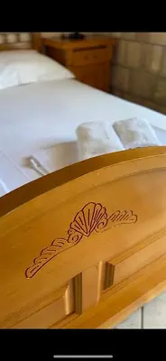a close up of a wooden foot board of a bed at Apartments Amina in Ulcinj