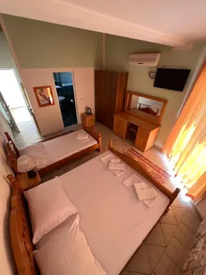 a view of a bedroom with two beds and a mirror at Apartments Amina in Ulcinj