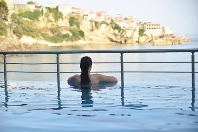 a woman sitting in a pool of water at Apartments Eneida in Ulcinj