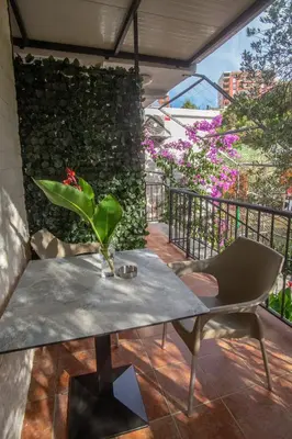 a table and a chair on a patio at Apartments Oliva in Utjeha