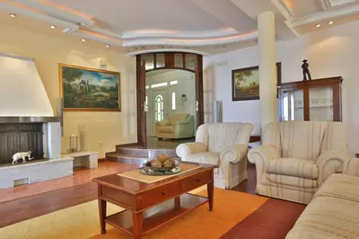 a living room with two chairs and a coffee table at Royal Holiday Apartments Sveti Stefan in Sveti Stefan