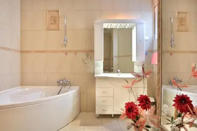 a bathroom with a tub and a sink and a mirror at Royal Holiday Apartments Sveti Stefan in Sveti Stefan