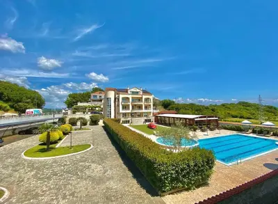 a resort with a swimming pool and a building at Apart Hotel Llolla in Ulcinj