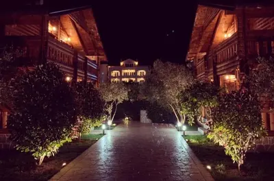 a building at night with a walkway with trees and lights at Apart Hotel Llolla in Ulcinj
