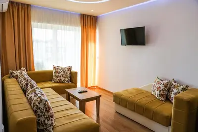 a living room with two couches and a tv at Apart Hotel Llolla in Ulcinj