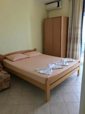 a bedroom with a bed with two towels on it at Apartments Popovic in Ulcinj