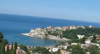 a view of a town on a hill next to the ocean at Apartments Popovic in Ulcinj