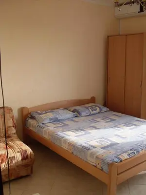 a bedroom with a bed and a chair at Apartments Popovic in Ulcinj