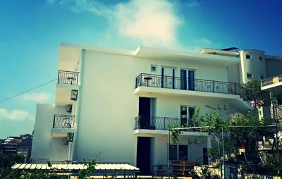 a white building with balconies on the side of it at Apartments Popovic in Ulcinj