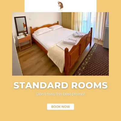 a bed in a room with avertisementforgrimgrimgrimgrimgrimgrimgrim at Hotel Kleopatra in Ulcinj
