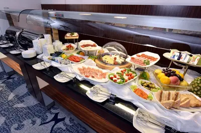 a buffet line with many different types of food at Hotel Ziya in Podgorica