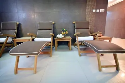 a group of chairs in a room with a table at Hotel Ziya in Podgorica