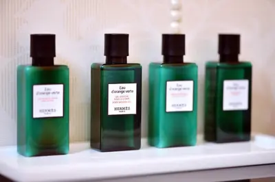 four bottles of soap sitting on a shelf at Hotel Ziya in Podgorica