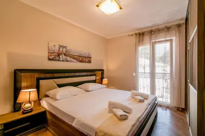 a bedroom with a bed with two towels on it at Apartmani Matej in Kotor