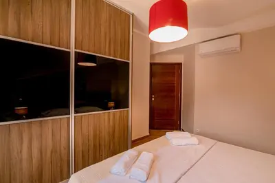 a bedroom with a bed with two towels on it at Apartmani Matej in Kotor
