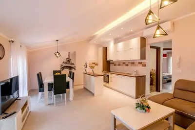 a living room and kitchen with a couch and a table at Apartmani Matej in Kotor