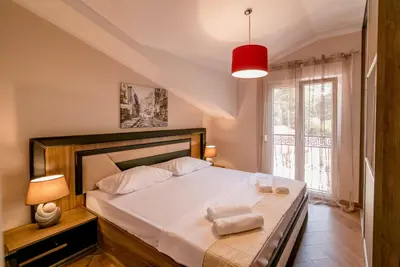 a bedroom with a bed with two towels on it at Apartmani Matej in Kotor