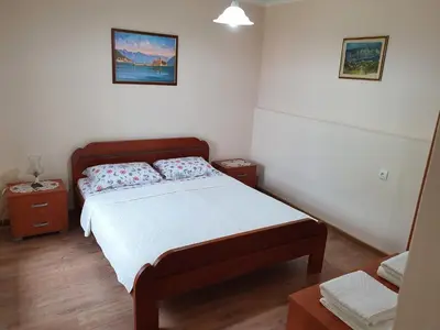 a small bedroom with a bed and two night stands at Apartment Marta in Kotor