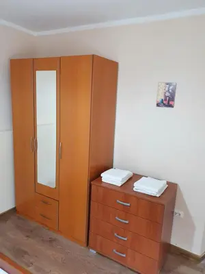 a bedroom with a wooden cabinet and a dresser at Apartment Marta in Kotor